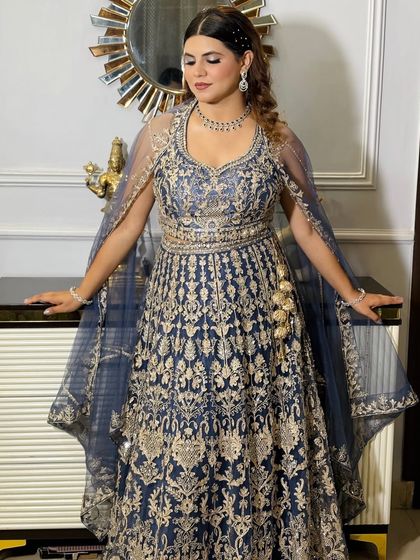 The client looking down, showcasing the eyeshadow and the intricate details of her dress.