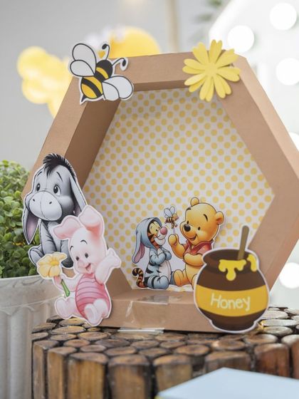 A honeycomb-shaped shadow box with tiny cutouts of Pooh and his friends. I love creating these unique, handcrafted details.