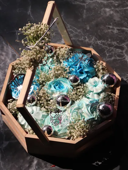 Another view of the blue cupcake hamper, showing how the baby's breath flowers fill the gaps and complete the look.