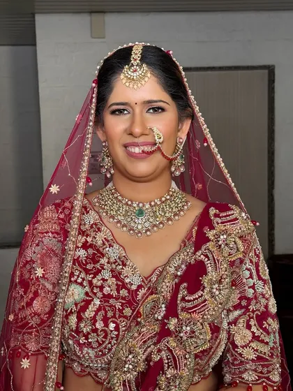 A classic portrait of the bride. The traditional updo is perfectly suited for her face shape and the heavy embroidery of her wedding attire.