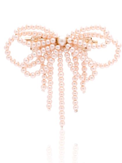 Brooch please. This peach pearl bow brooch is handcrafted to add an extra touch of elegance to your everyday look.