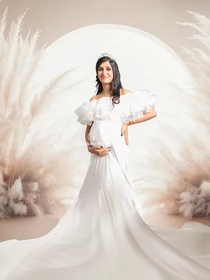 For the mom-to-be who dreams of a fairytale moment. This setup features a regal white gown, a tiara, and a dreamy pampas grass arch, creating an ethereal and angelic portrait. It’s about making you feel like the queen you are during this special time.