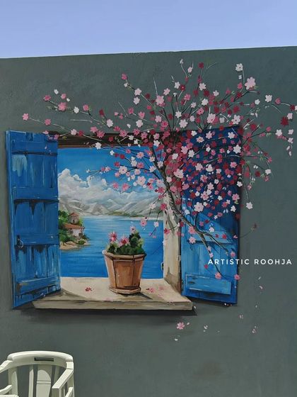 A close-up of the 3D window mural, showing the detail in the cherry blossoms and the illusion of depth in the landscape.