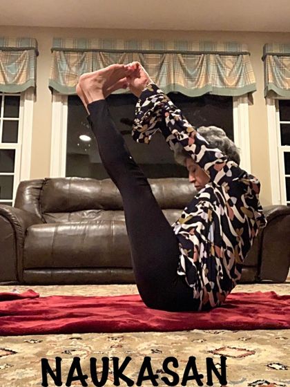Holding Naukasan, a powerful core-strengthening posture that we practice regularly in my classes.
