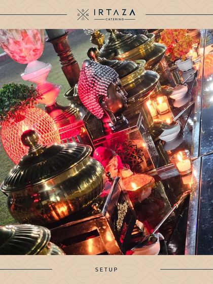 A vibrant and eclectic buffet arrangement glowing under red light, showcasing a mix of decorative items and serveware for a visually exciting display.