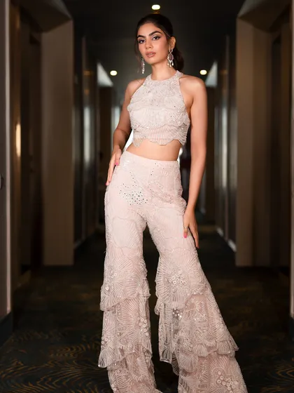This halter-neck sharara set with tiered pants is a fun and fashionable choice for a bridesmaid or wedding guest. The delicate embroidery and modern cut make it a standout piece for any celebration.