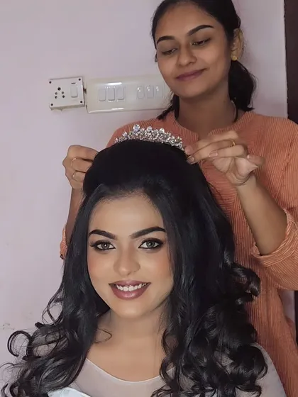 A behind-the-scenes shot of me placing the tiara on a model for a Christian wedding look. It's all about the details!