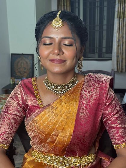 A close-up of Gopika's subtle engagement makeup. Her eyes are closed, showing the soft, blended eyeshadow and perfectly defined brows that create a natural yet polished look, ideal for dusky skin tones.