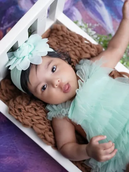 A playful, expressive moment from the two-month session, capturing her personality as she reaches out.