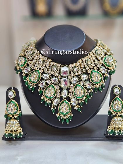 This grand bridal choker combines Kundan, Meenakari work, and American diamonds for a spectacular effect.