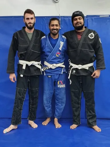 Posing with two practitioners after a session. It's inspiring to see students from different walks of life connect through the shared language of Jiu-Jitsu.