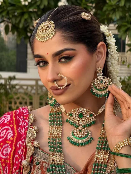 A close-up of the final look. The sharp eyeliner, bronzed skin, and bold lip are signatures of a classic yet contemporary South Indian bride.