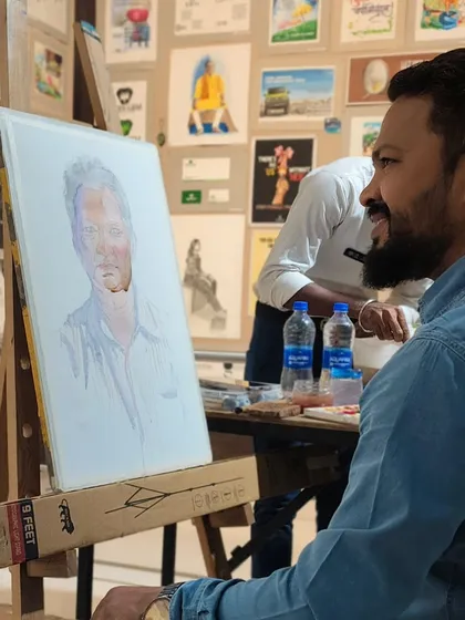 A candid moment during the demonstration, with my mentor's portrait developing on the easel.