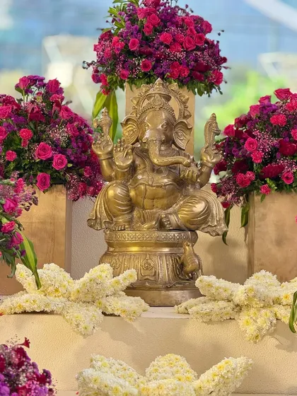 Different angles of the auspicious welcome corner. The Ganesha idol, a symbol of new beginnings, is beautifully adorned with flowers, setting a blessed tone for the celebration.