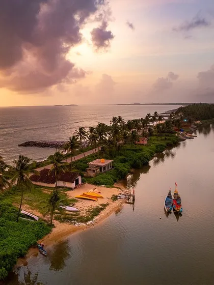 An aerial perspective captures the dramatic meeting of land and water. This thin strip of land, nestled between the serene backwaters and the vast Arabian Sea, showcases the unique coastal geography of Namma Karnataka.