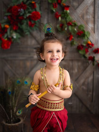 That mischievous smile! This little Krishna, with his peacock feather and flute, perfectly captures the playful spirit of the festival.