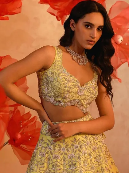 A vibrant yellow lehenga with intricate silver embroidery. This is a perfect choice for a haldi ceremony or any daytime wedding event.