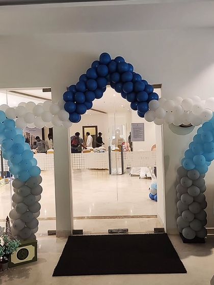 A house shaped balloon arch for a Boss Baby themed party entrance, creating a fun and inviting doorway for the little guests.