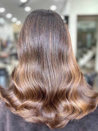 This is a perfect example of a classic balayage, with light-reflecting strands creating a glossy, multi-dimensional effect.
