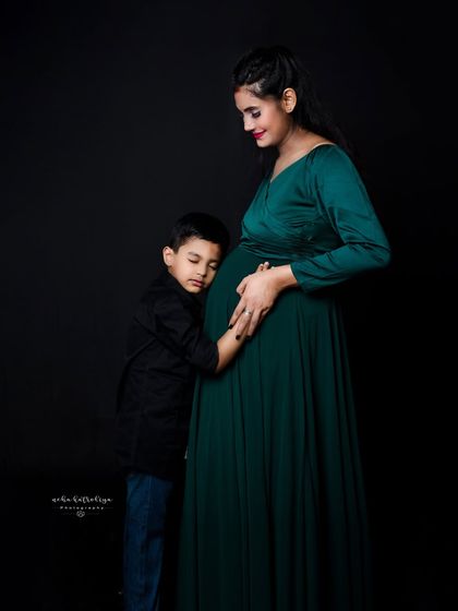A sweet moment of connection between a mother and her older son as they both embrace the baby bump. Sibling involvement in maternity sessions makes for incredibly touching photographs.