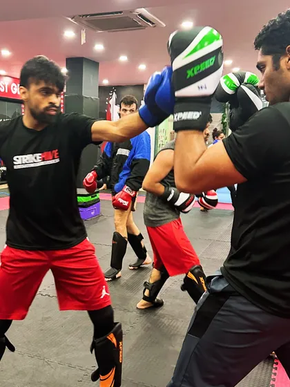 A student throws a straight right hand during a sparring session. We teach how to generate power from the ground up, ensuring every punch is both effective and efficient.