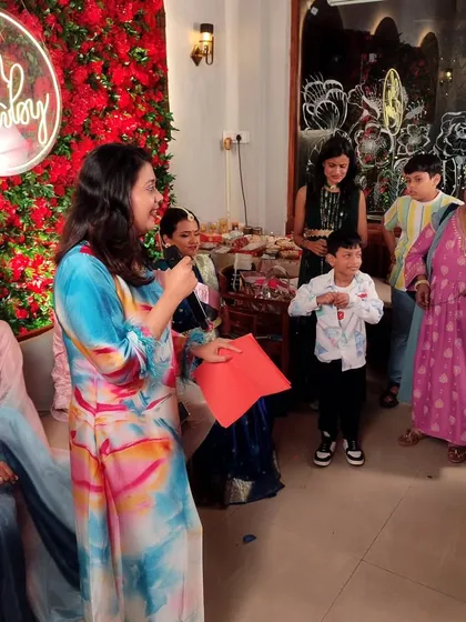 Engaging with the kids during a game at Pranita and Gaurav's baby shower. Making sure the little ones are entertained is a crucial part of hosting a successful family event.