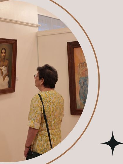 A visitor contemplates a portrait, showcasing the engagement and curiosity we love to see in our gallery.