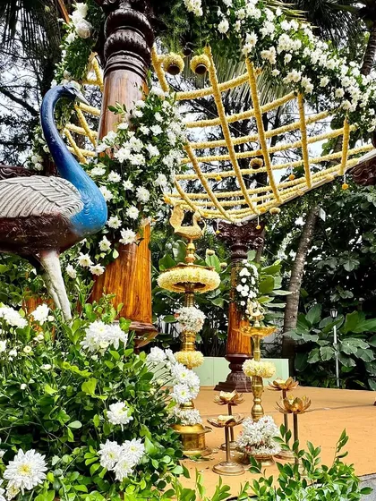 A unique mandap design featuring peacock statues and a canopy made of woven jasmine, blending natural and artistic elements for a stunning effect.