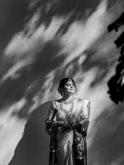 When a bride is ready ahead of schedule, it gives us time to play with light and shadow. This portrait of Srushti at the Turf Club is one of my favorites. I used the natural shadows from the leaves to create this dramatic, artistic black and white bridal shot that feels both timeless and modern.