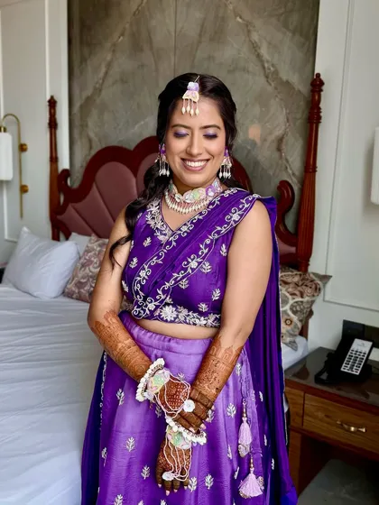 A beautiful portrait of the bride in her room. The makeup is flawless, and she looks ready for her Haldi ceremony.