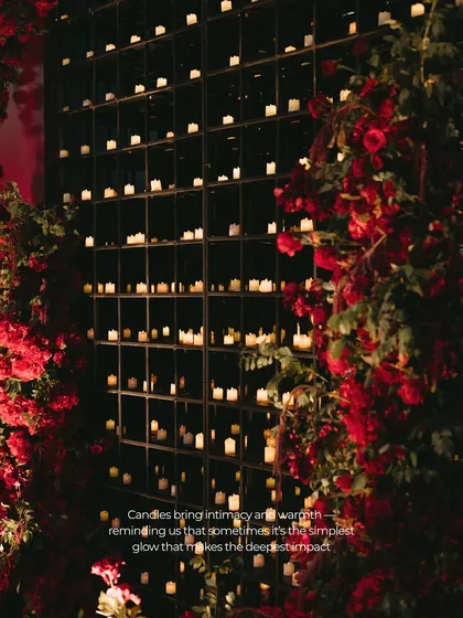 Lighting is storytelling. Here, a towering wall of over a thousand candles created a backdrop of intimate, flickering warmth. It’s a simple concept with a powerful impact, designed to evoke a sense of timeless romance and pure magic.