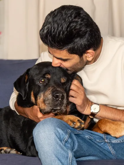 A tender moment between a man and his rescued Rottweiler, Jag. This photo shows the gentle, loving side of a breed often misunderstood.