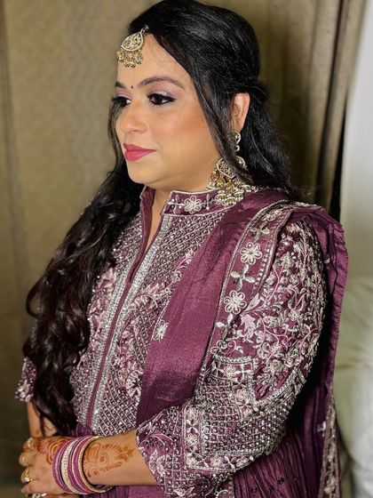 A side profile, showing the intricate embroidery on her outfit.