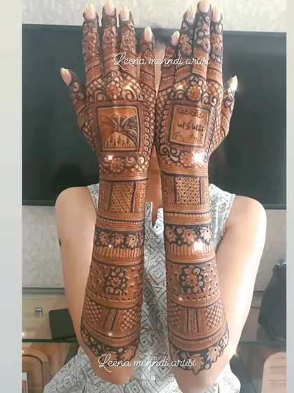 A full-coverage bridal design that extends up the arms. Notice the personalized elements like the kalash and the custom text, which we can incorporate to make your mehndi unique.