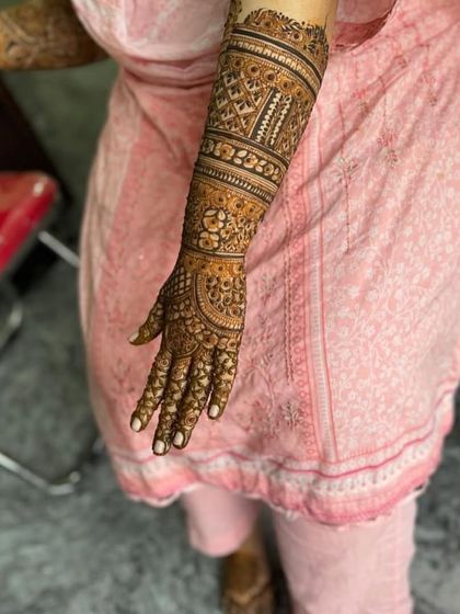 The back of a full-arm design, featuring geometric bands and intricate filler patterns.