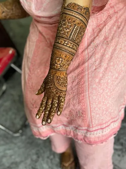 The back of a full-arm design, featuring geometric bands and intricate filler patterns.