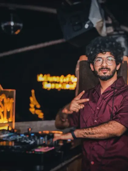 Posing for a quick photo behind the decks at Cafe Mambo. It's important to me to be approachable and connect with the audience during my sets.