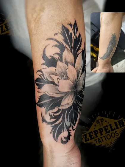 A before-and-after look at a common tattoo cover-up. I transformed a simple feather tattoo on the wrist into an elegant floral design, using dark leaves and soft shading to completely hide the old ink while creating a beautiful new piece.