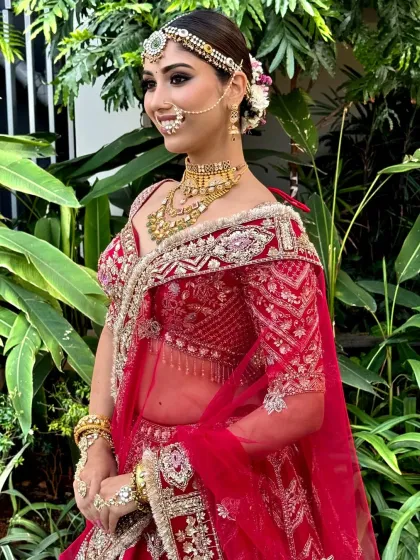 A side profile of a model with a floral bun, highlighting the intricate placement of the flowers and the sleekness of the hairstyle.