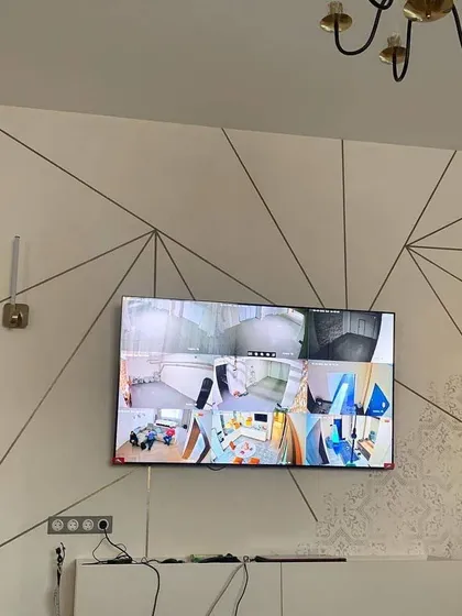 A large screen displaying a multi-camera feed in a modern living room. Security can be both effective and stylish.