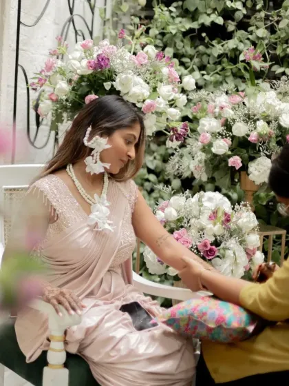 A behind-the-scenes moment of the bride getting her henna done, looking serene and beautiful.