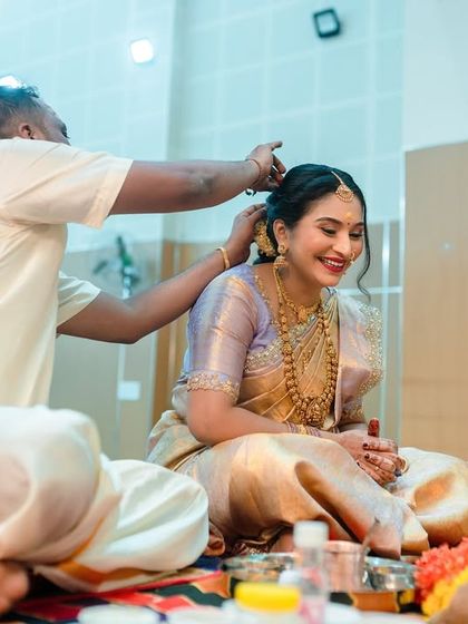 Capturing the details of the rituals is a key part of my event photography. Here, a family member helps the mom-to-be with her hair during the ceremony.