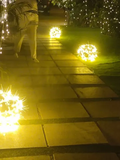A stone pathway lit by glowing orbs on the ground. We believe the journey through our venue should be as beautiful as the destination.