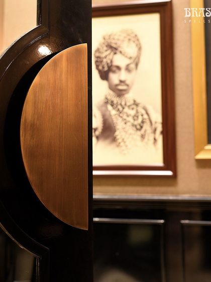A detail of the custom semi-circular door handles I designed for the store. The warm brass finish and clean, modern shape provide a tactile and visual welcome, echoing the blend of tradition and modernity central to the Valaya brand.