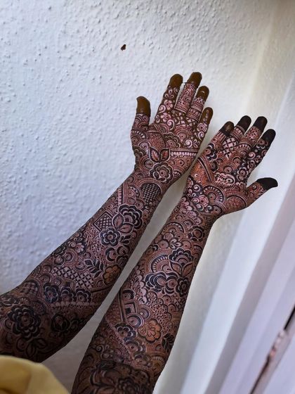 A clear shot of the full design, showing the beautiful symmetry and the name 'Hussein' on the palm.