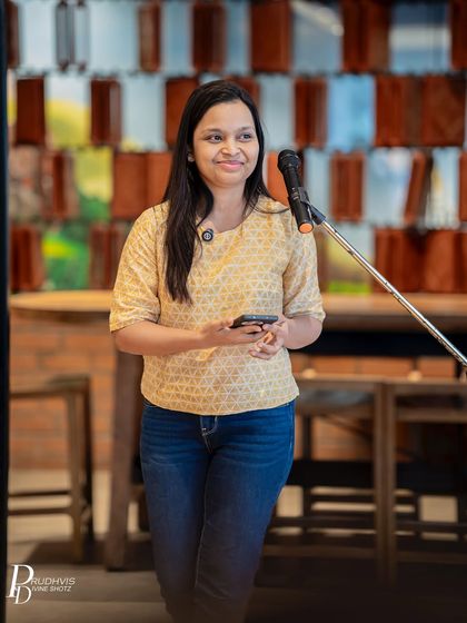 A performer waits for her turn, a gentle smile on her face. The supportive atmosphere at our events makes everyone feel welcome.
