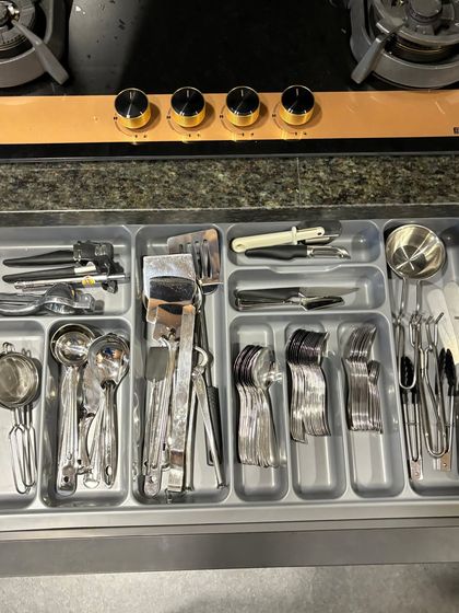 A cutlery drawer right below the stove, keeping all essential cooking and eating utensils within arm's reach.