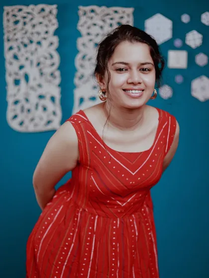 A happy, candid-style portrait. The genuine smile is what makes this shot so special. We used a simple blue background to make the red dress pop.