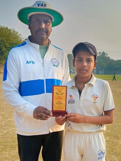 Piyush Neupane with his award after scoring 110 not out.