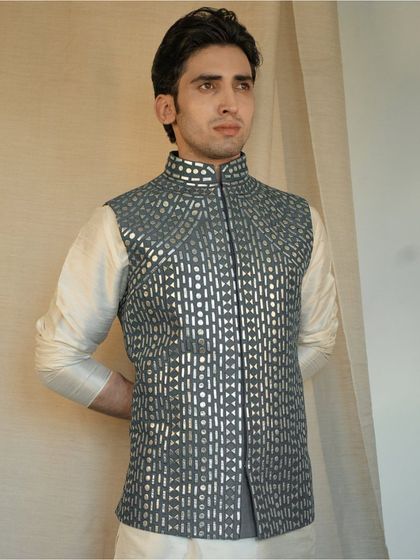 We pair this exquisite jacket with a classic white kurta for a timeless and sophisticated look that exudes elegance and refinement.